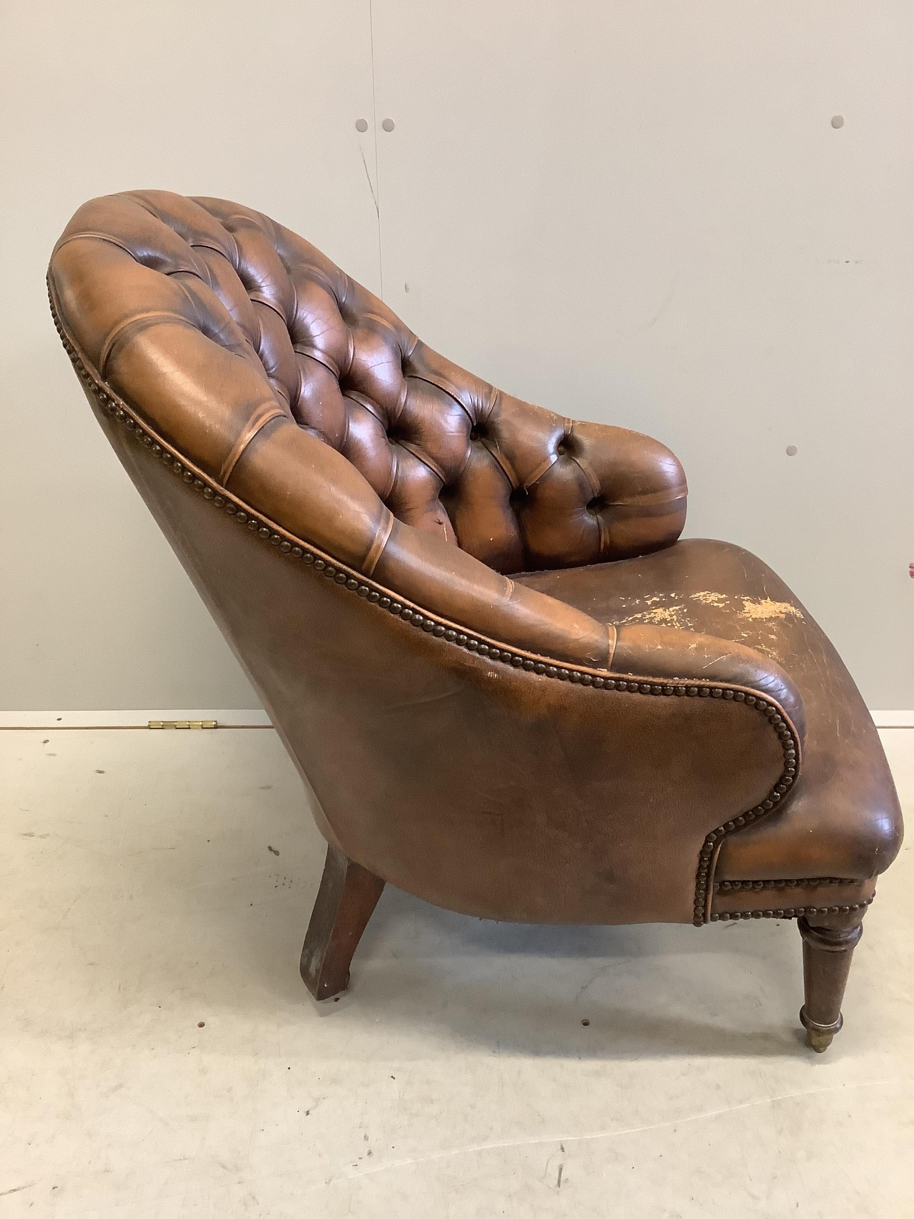 A Victorian style buttoned brown leather tub framed library chair, width 64cm, depth 74cm, height 80cm. Condition - fair, seat poor